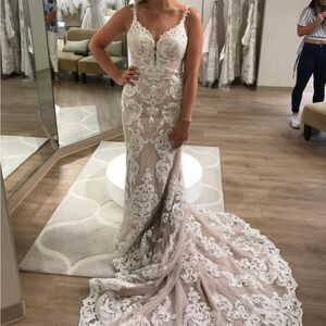 Beautiful beaded sleeveless V neck fit and flare Martina Liana wedding dress.